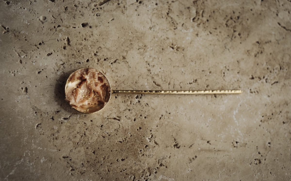 pale pink sorbet balm in a brass spoon