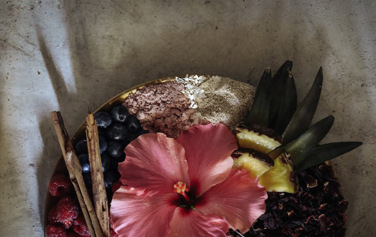 flatlay of hibiscus, pineapple and cinnamon