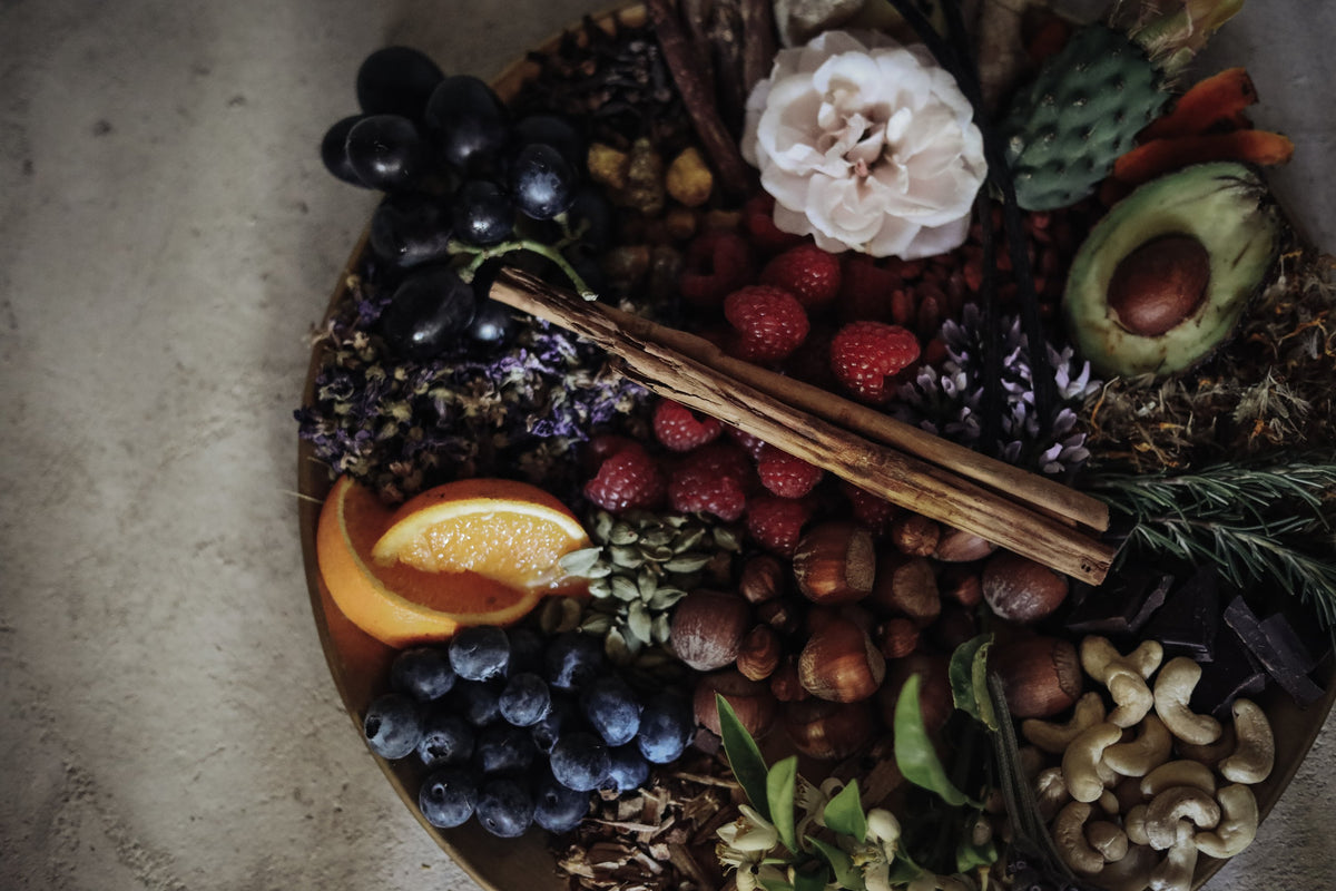 flatlay of blueberries, grapes, orange and cinnamon