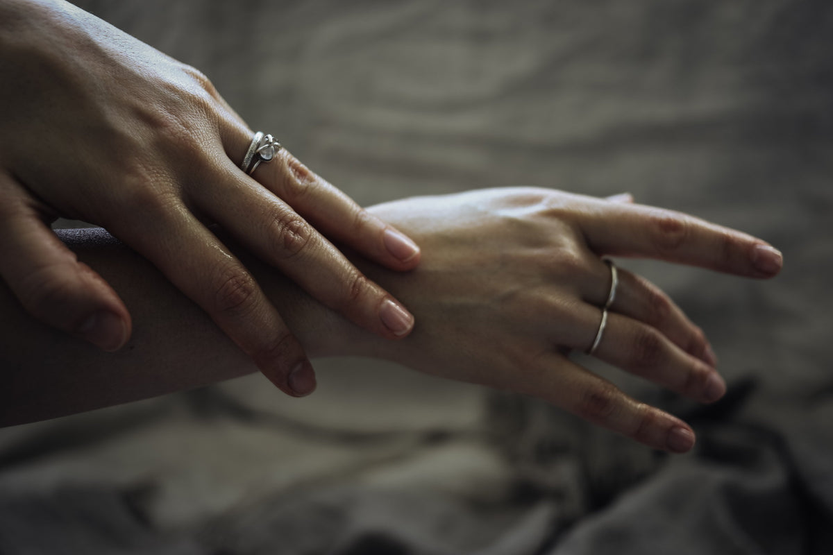 hand stroking the back of the other hand
