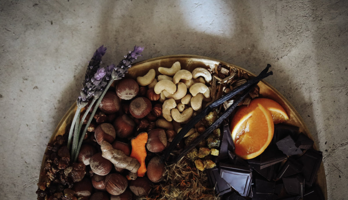 flatlay of cashews, cacao and orange