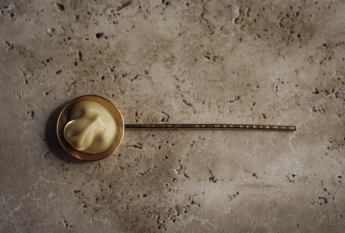 kokon cream concentrate in a brass spoon