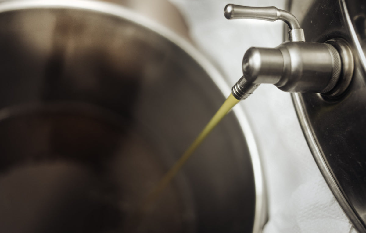 oil running from the tap of a steel vessel