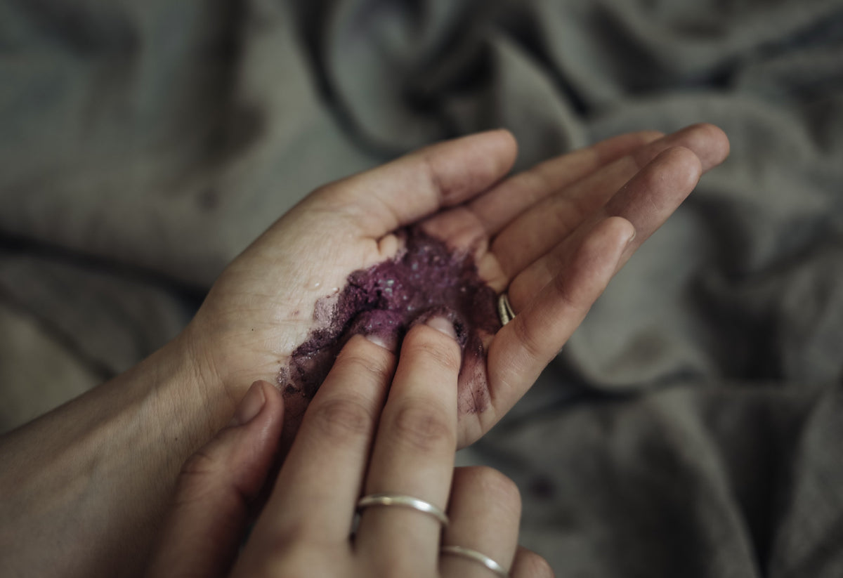 Violettes Pulver in einer Handfläche