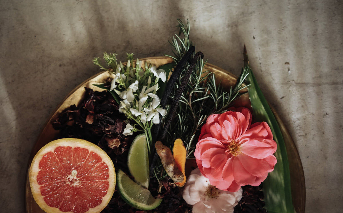 flatlay of grapefruit, rosemary and blossoms